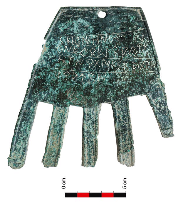 <p>The 2100 year old sheet bronze ‘severed hand’ symbol, with its inscription probably referring to a ‘good fortune’ deity</p>